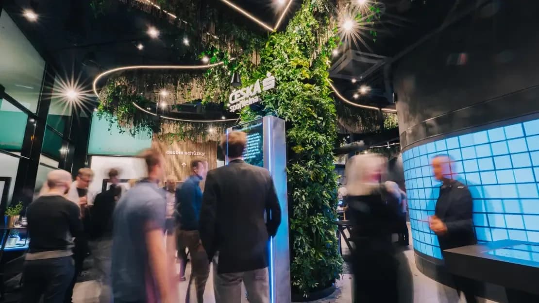 Visitors walking through the Future Lab, motion blur, kiosk in background
