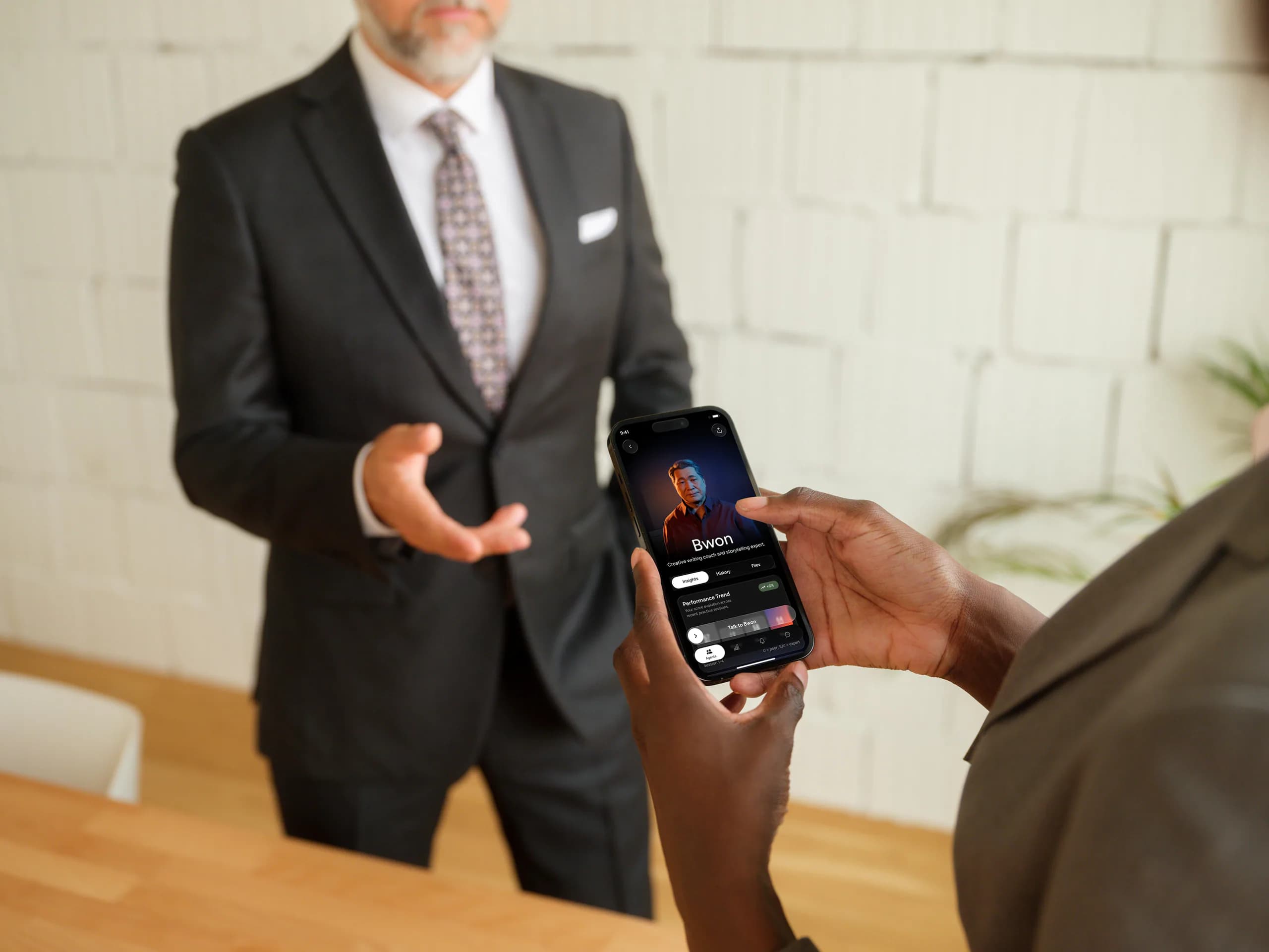 Professional reviewing Empower coaching results on iPhone